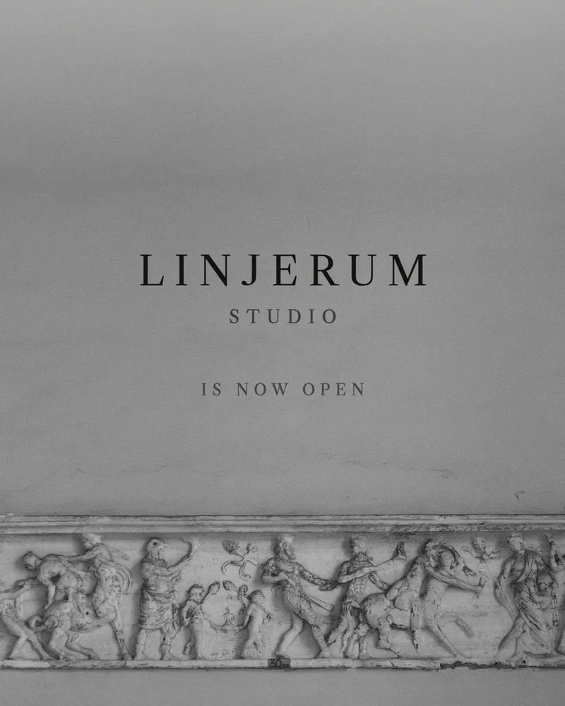 En udhugget marmorfrise under ordene 'LINJERUM Studio is now open'.